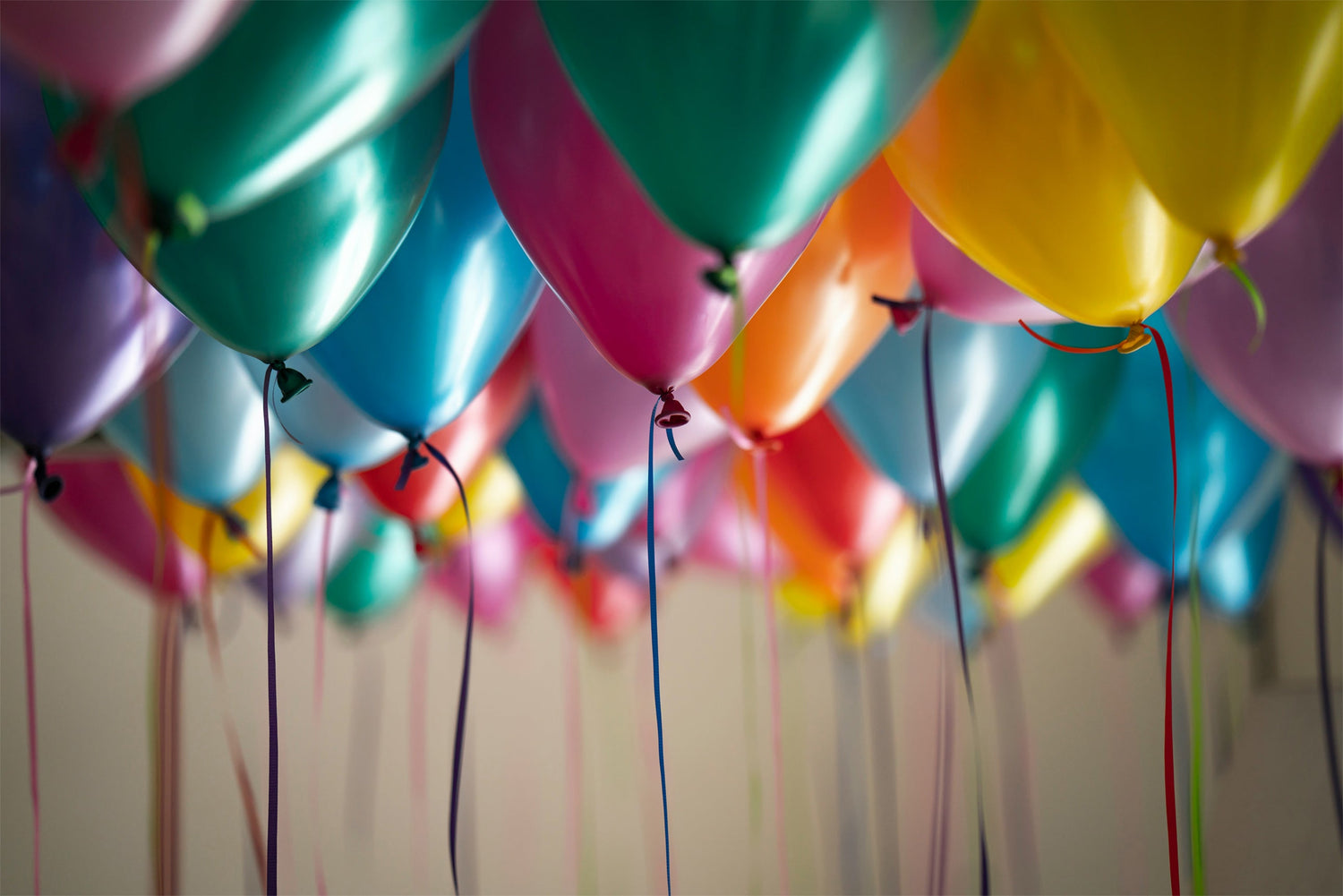Image shows lots of colourful balloons probably for a birthday celebration